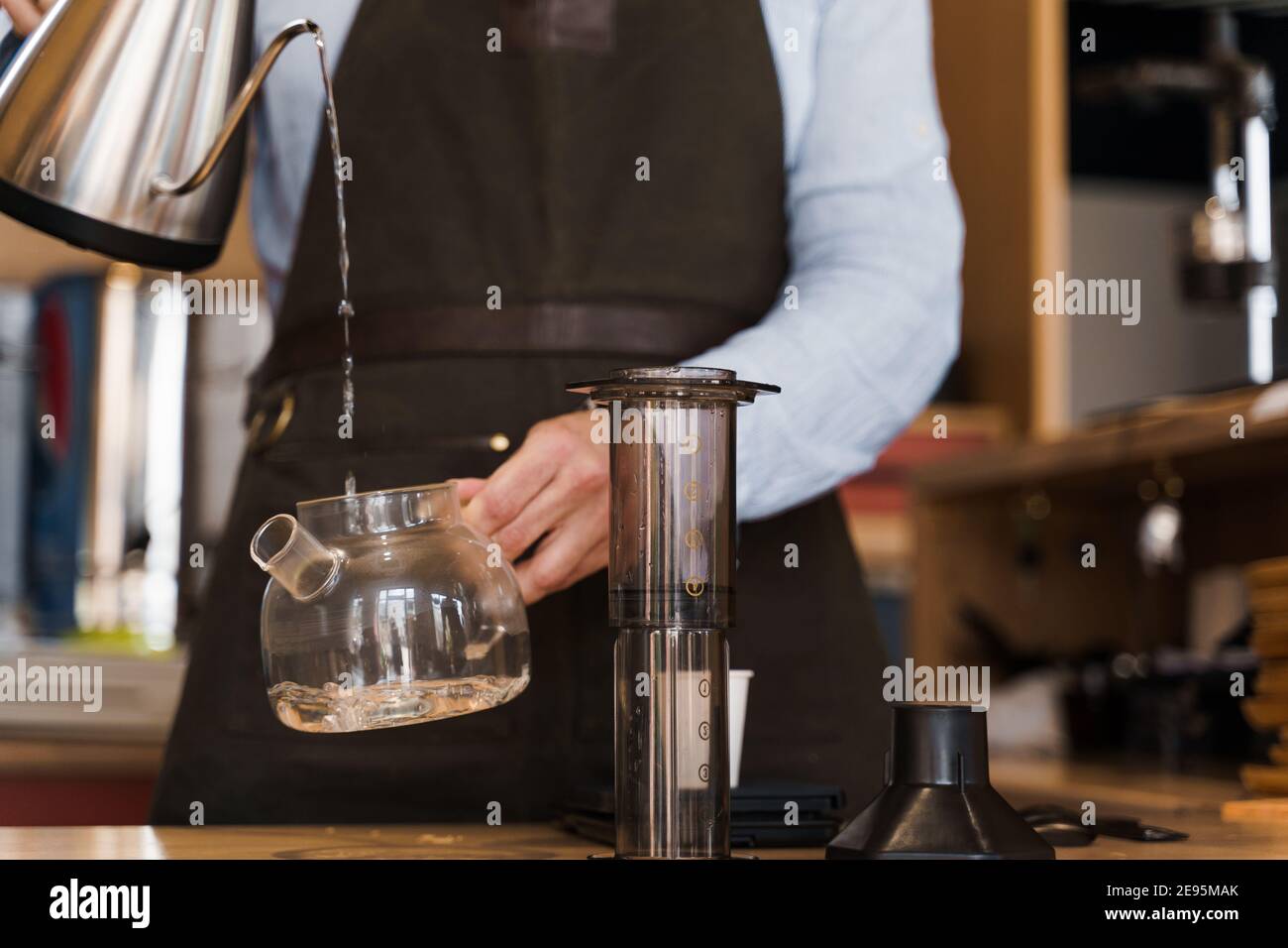 https://c8.alamy.com/comp/2E95MAK/aeropress-coffee-alternative-making-by-barista-in-the-cafe-barista-pours-hot-water-in-pot-for-making-aeropress-coffee-with-special-device-advert-for-2E95MAK.jpg