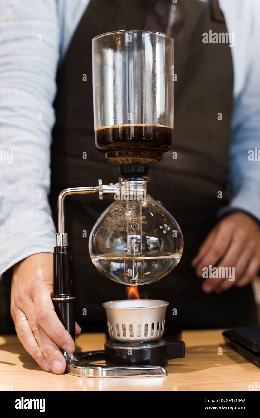 Coffee brewing by Syphon device. Close 