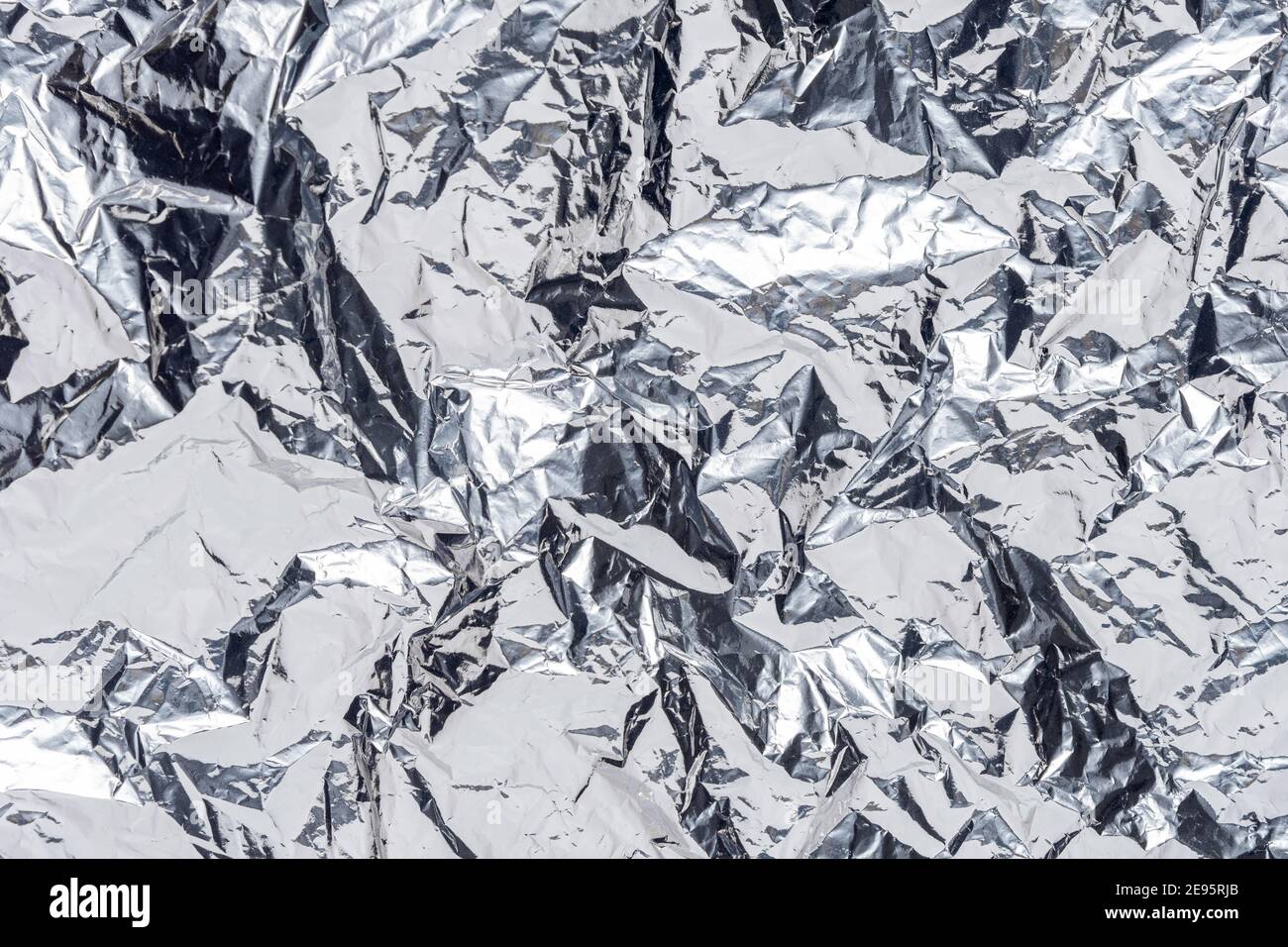 Abstract silver crumpled foil background. Minimal party concept. Stock Photo
