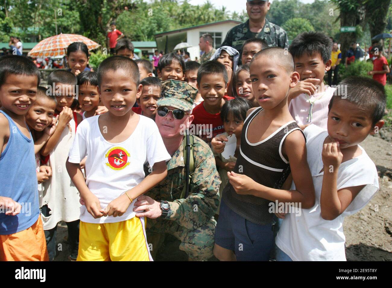 Colonel Walter L. Miller, Jr., commanding officer of the 31st Marine Expeditionary Unit spends a few moments with children from the area around the devastated town of Guinsahugon located in the southern part of the island of Leyte in the Philippines. Guinsahugon was destroyed February 17, 2006 by a mudslide from a nearby mountain. Photo USN via ABACAPRESS.COM Stock Photo