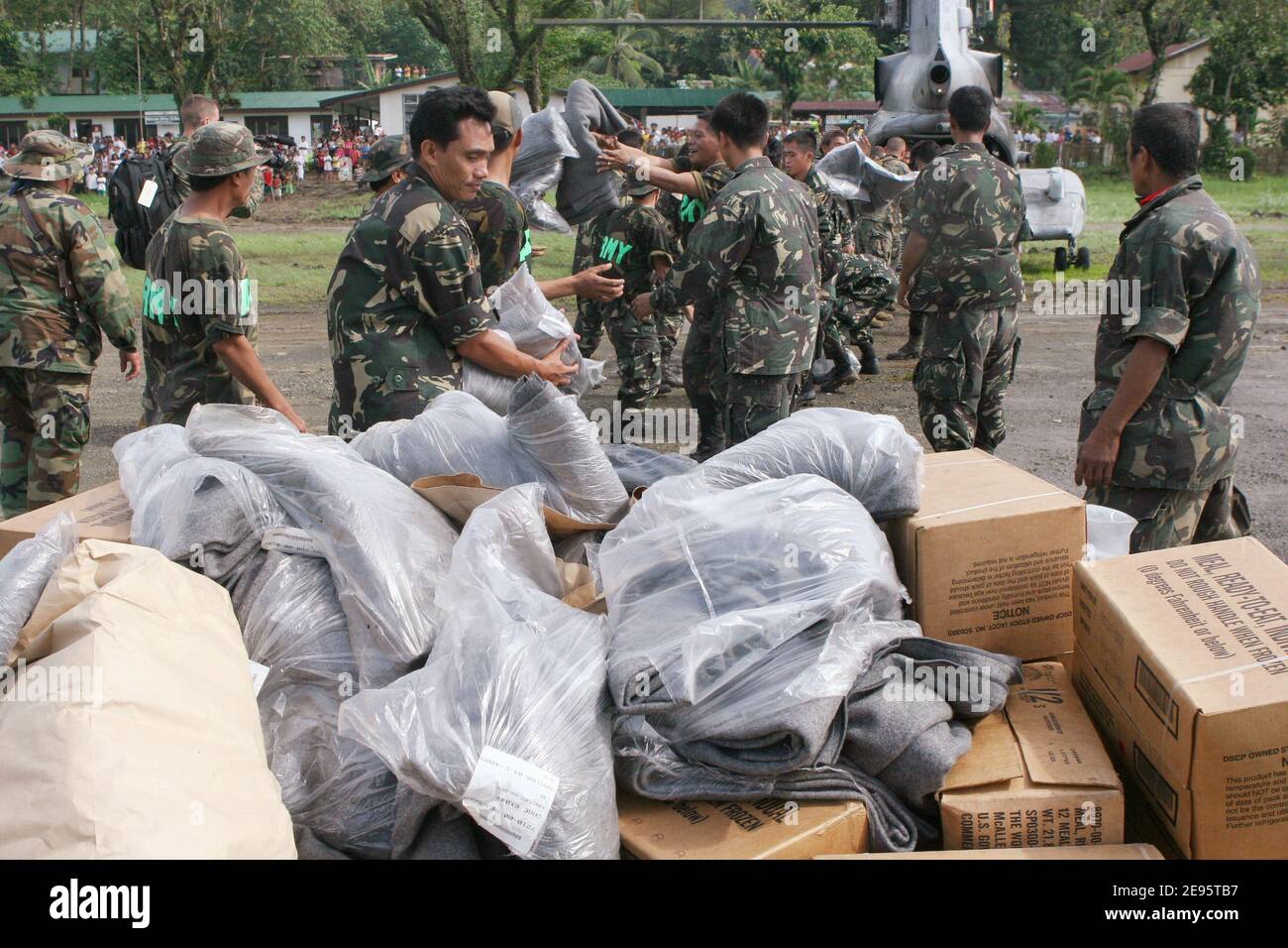 Members of the Philippine Army help U.S. Marines and Sailors, unload blankets from a CH-46E Sea Knight helicopter as part of the relief effort being conducted at the request of the Philippine government. This relief effort is a result of a mudslide, which took place the morning of February 17, 2006, and devastated the town of Guinsahugon located in the southern part of the island of Leyte in the Philippines. Photo USN via ABACAPRESS.COM Stock Photo