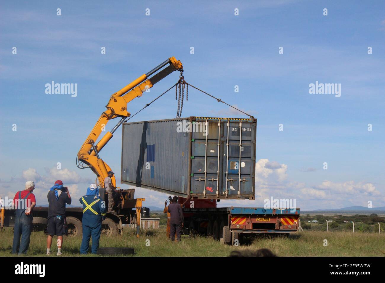 Crain moving a shipping container Stock Photo