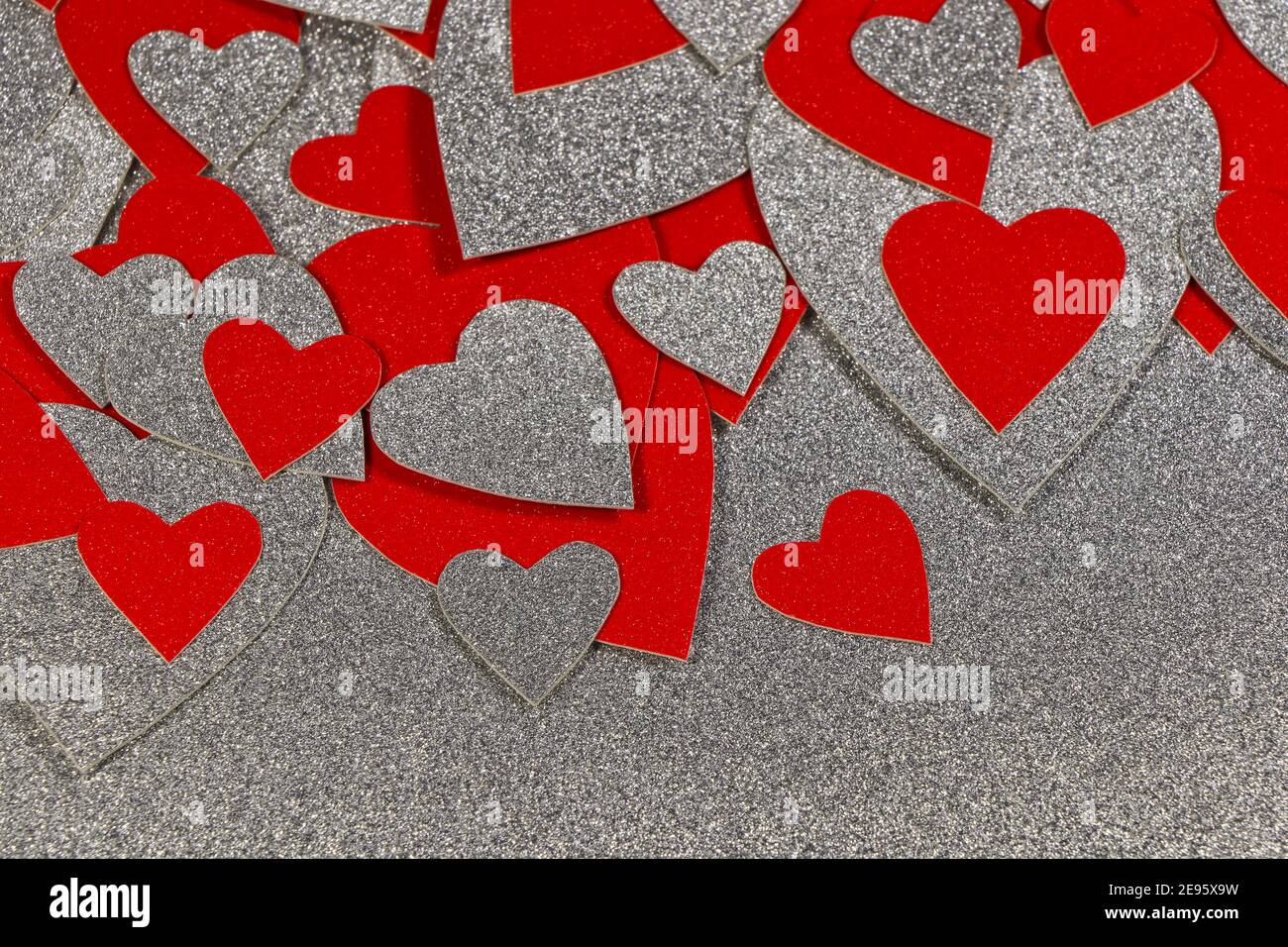 Scattered Red And Silver Hearts On Silver Stock Photo