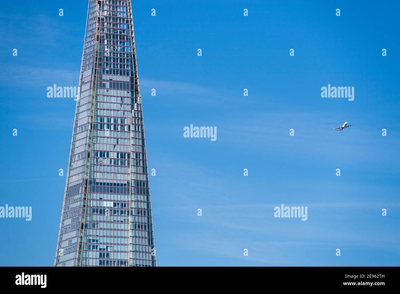 Low flying passenger plane close to the Shard on its final approach to landing at London City Airport, England, UK Stock Photo
