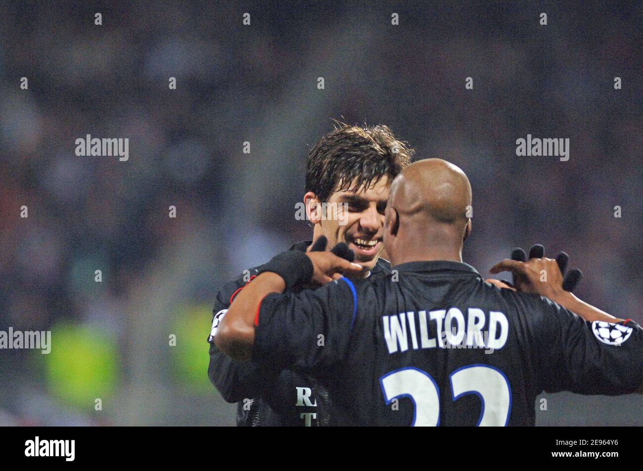 Olympic Lyonnais' Sylvain Wiltord celebrates his goal with team mate Juninho and Fred during the UEFA Champions league match, OLympic Lyonnais vs PSV Eindhoven at stade Gerland in Lyon, France on March 8, 2006. Olympic Lyonnais won 4-0. Photo by Stephane Kempinaire/Cameleon/ABACAPRESS.COM Stock Photo