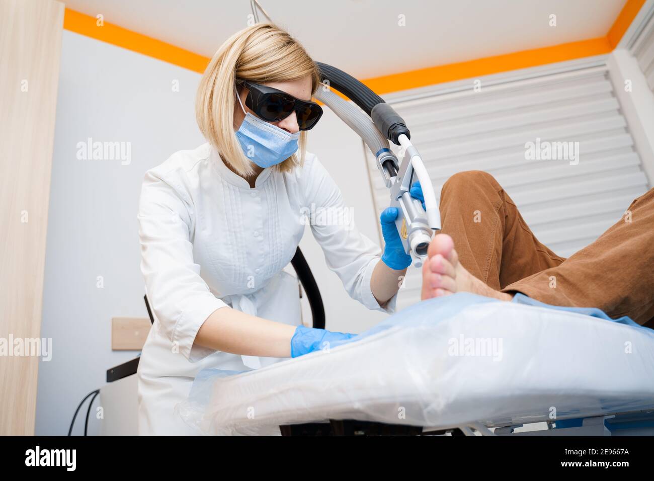 Laser removal of warts on the foot. Medical dermatological surgery in