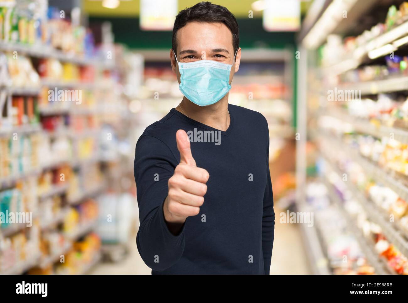Happy masked man shopping in a supermarket, covid coronavirus concept ...
