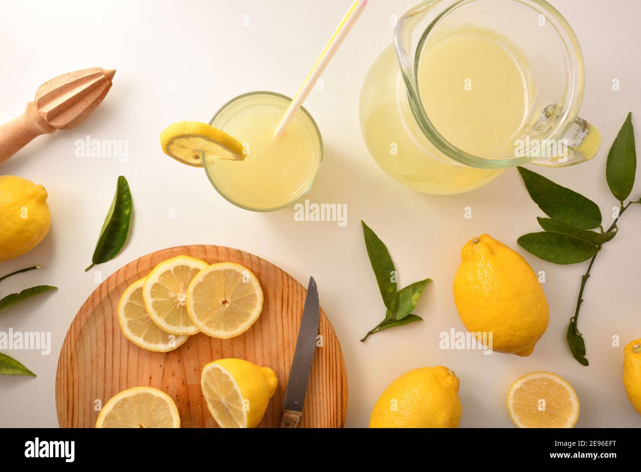 Freshly prepared lemon juice with utensils on the white kitchen bench. Top view. Horizontal composition. Stock Photo