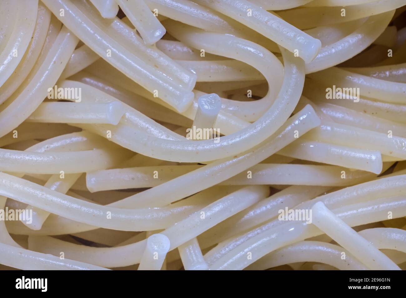 A closeup image of cooked spaghetti noodles show the texture of the