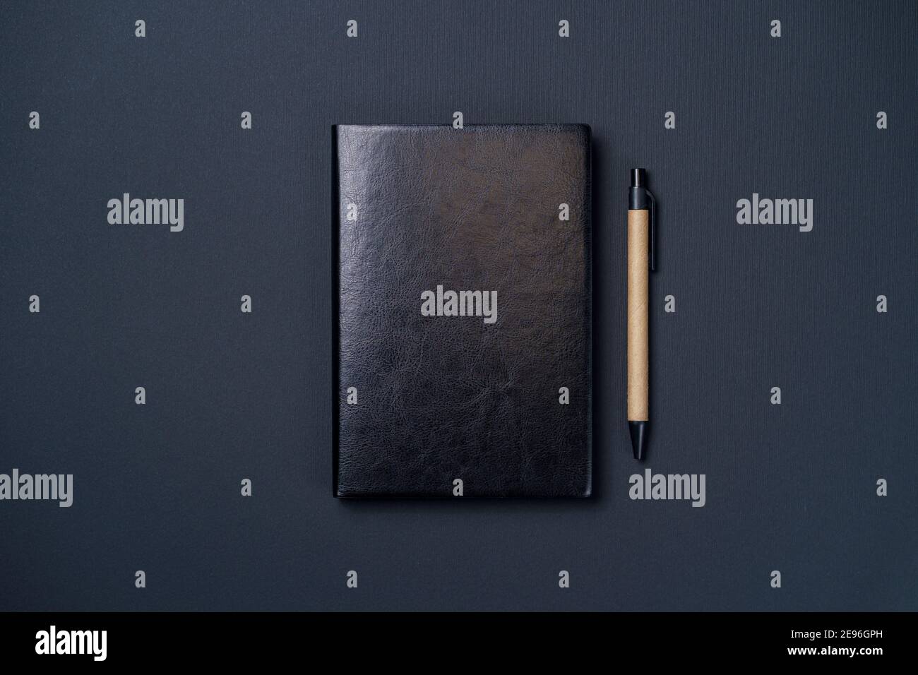 Black leather notebook on a paper black background, notepad mock up