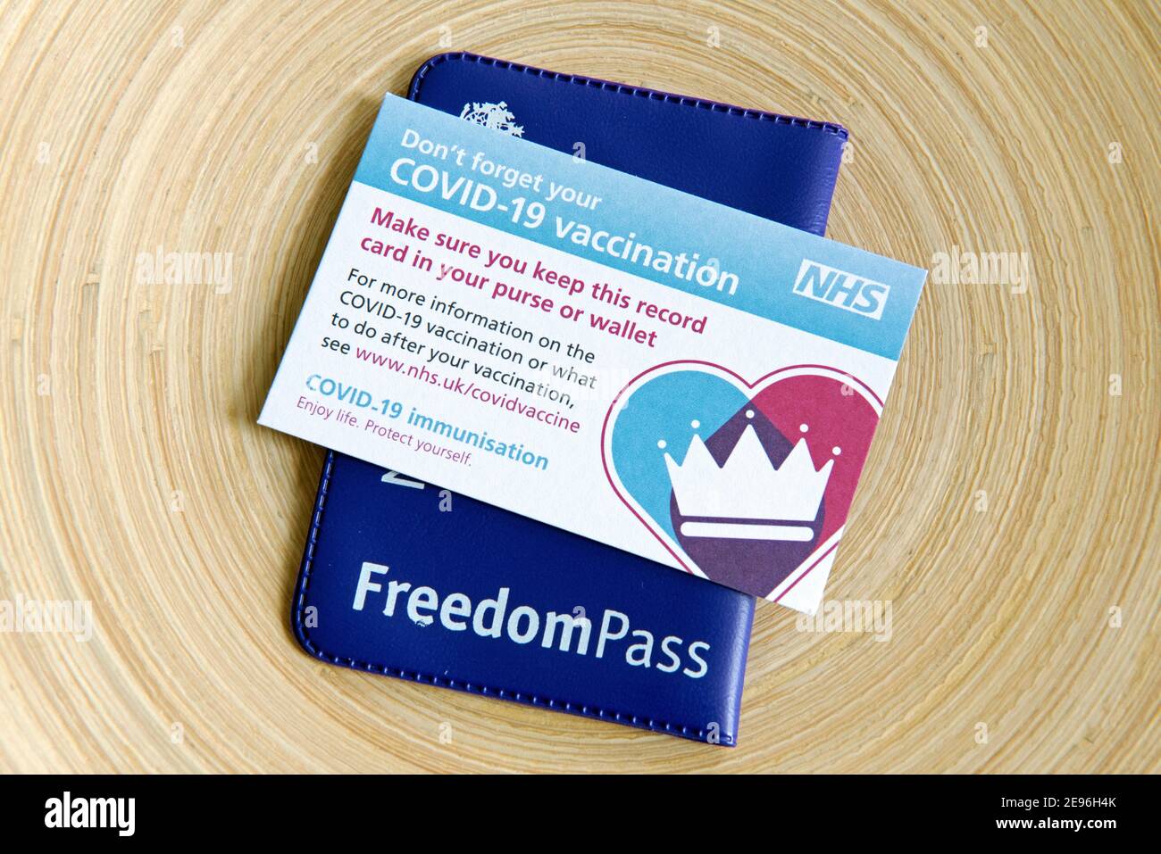 Covid-19 Vaccination or vaccine Card with Freedom Pass.  The elderly will soon be able to travel safely on public transport after their second jab. Fr Stock Photo