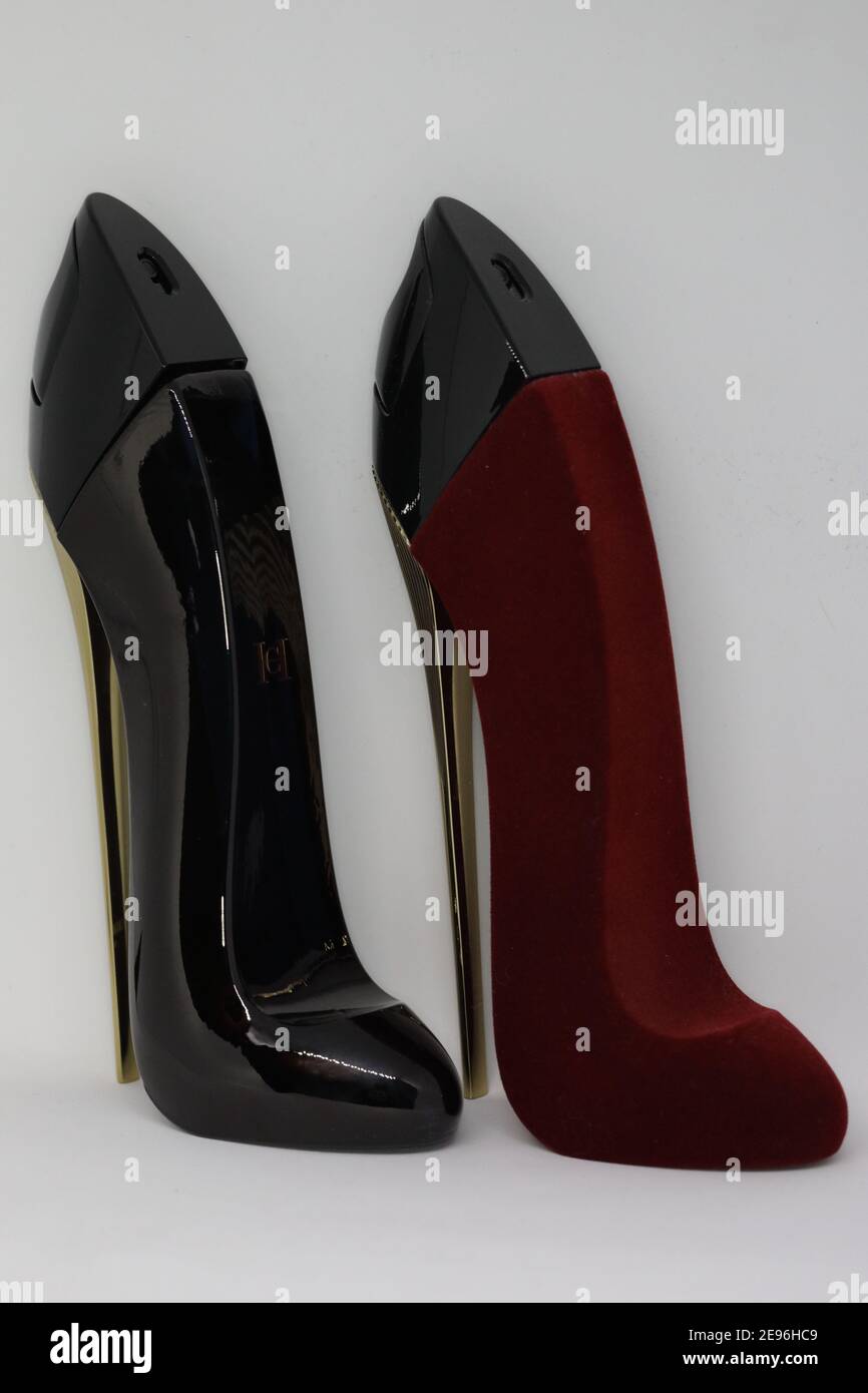 Two Perfume bottles that look like shoes one black and one red Stock Photo