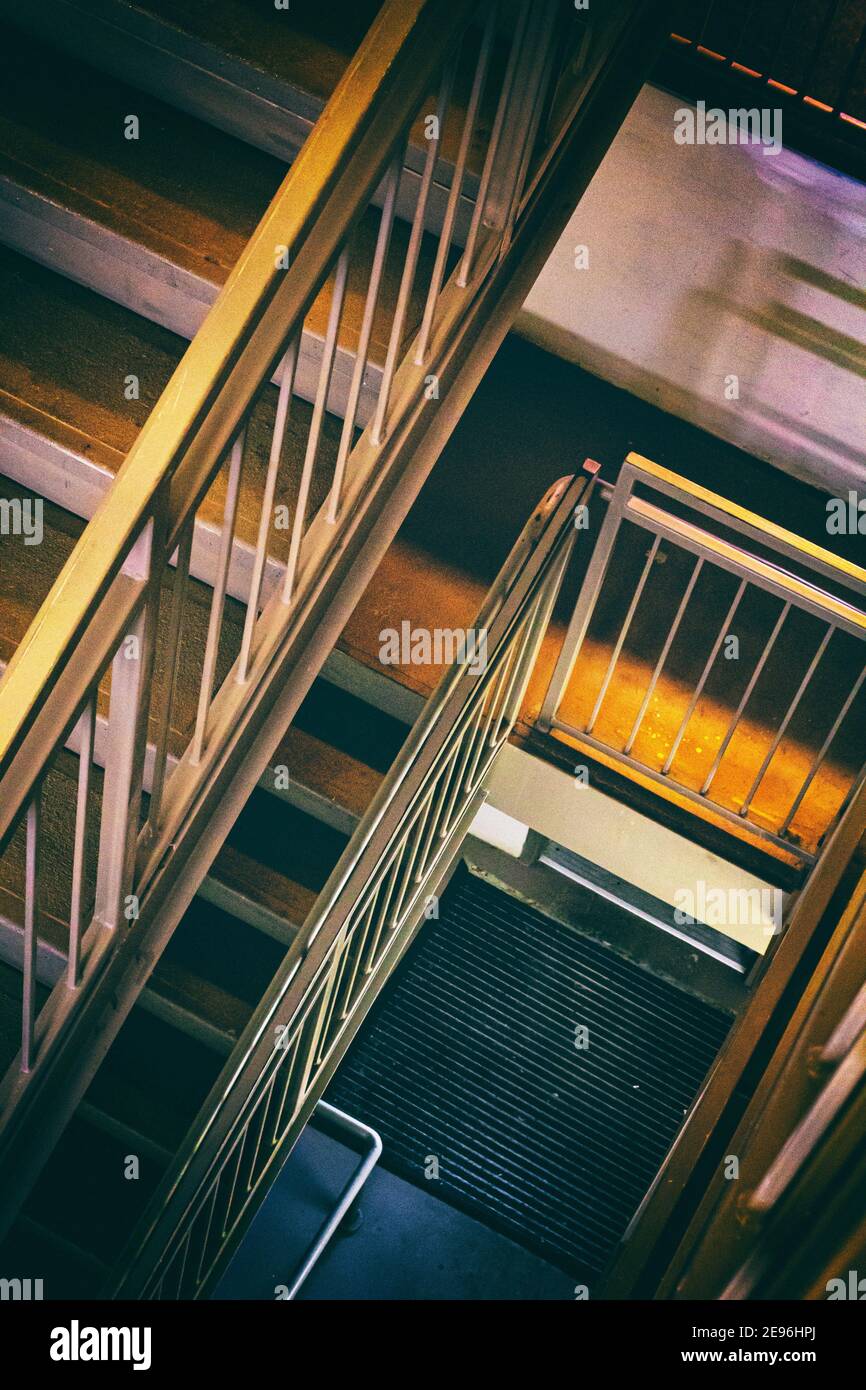 The lines of steps and railings in a stairwell create an abstract design. Stock Photo