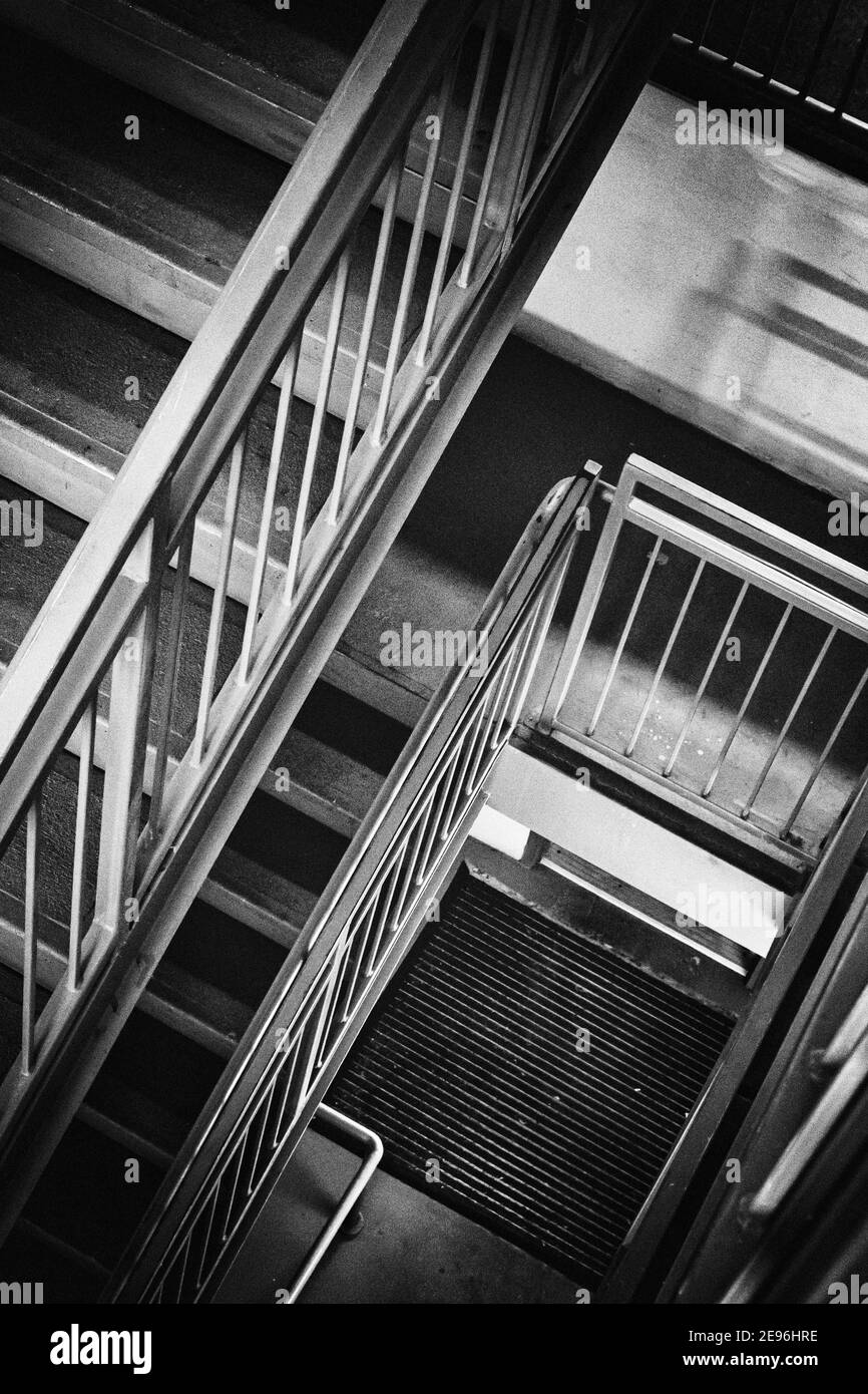 The lines of steps and railings in a stairwell create an abstract design. Stock Photo