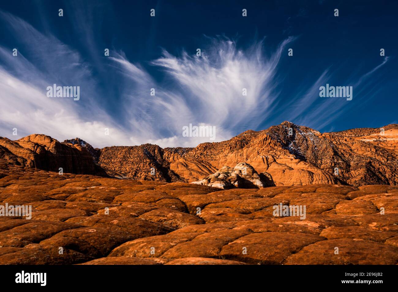 Beautiful cirrus clouds over the desert landscape of Snow Canyon State Park, Utah, USA. This park has fantastic geologic formations. Stock Photo