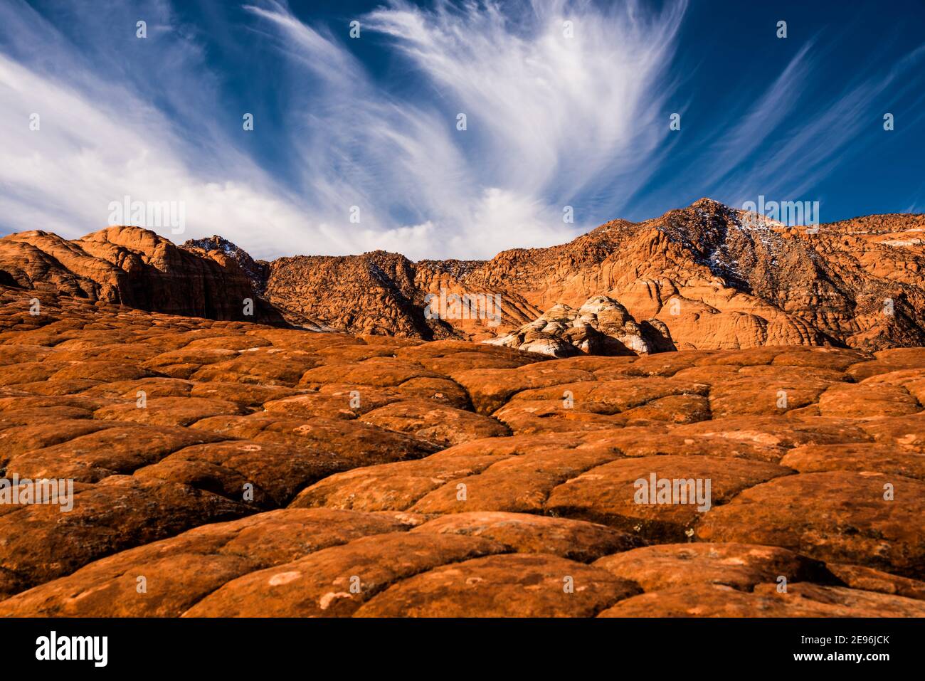 Beautiful cirrus clouds over the desert landscape of Snow Canyon State Park, Utah, USA. This park has fantastic geologic formations. Stock Photo