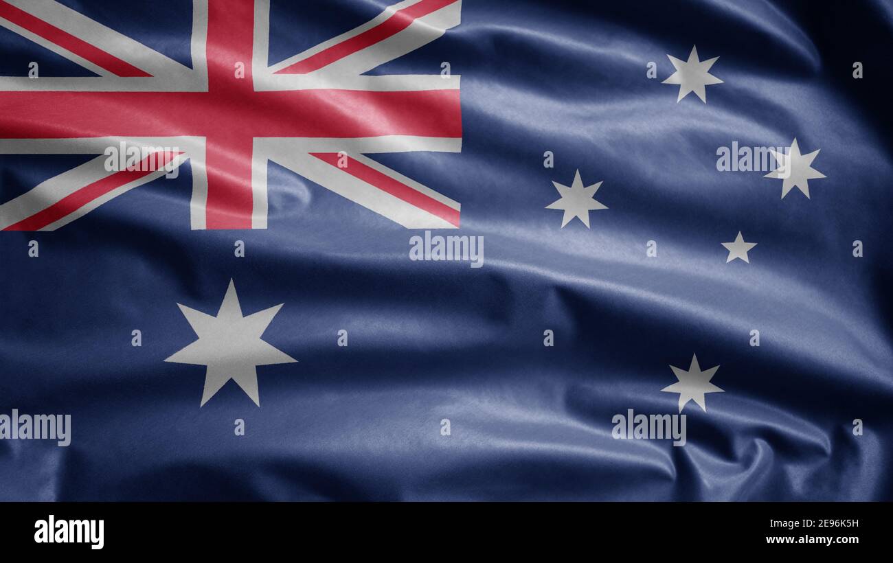 Australian flag waving in the wind. Close up of Australia banner blowing, and smooth silk. Cloth fabric texture ensign background. Use it Stock Photo -