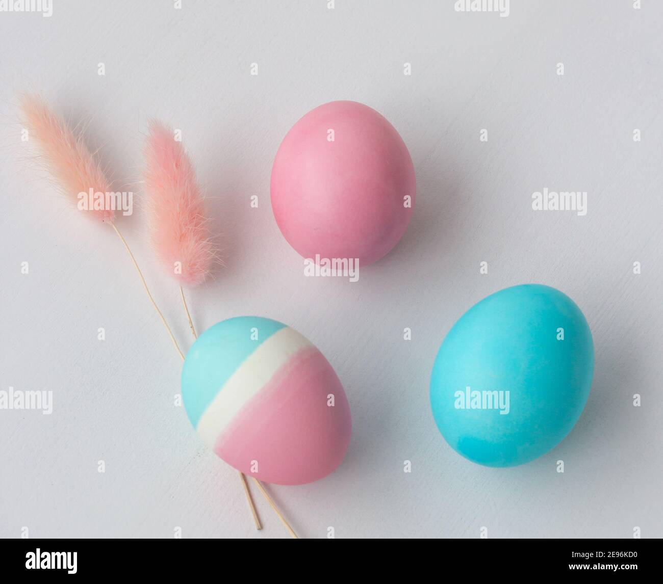 Delicate colors of Easter eggs on a white table, top view Stock Photo