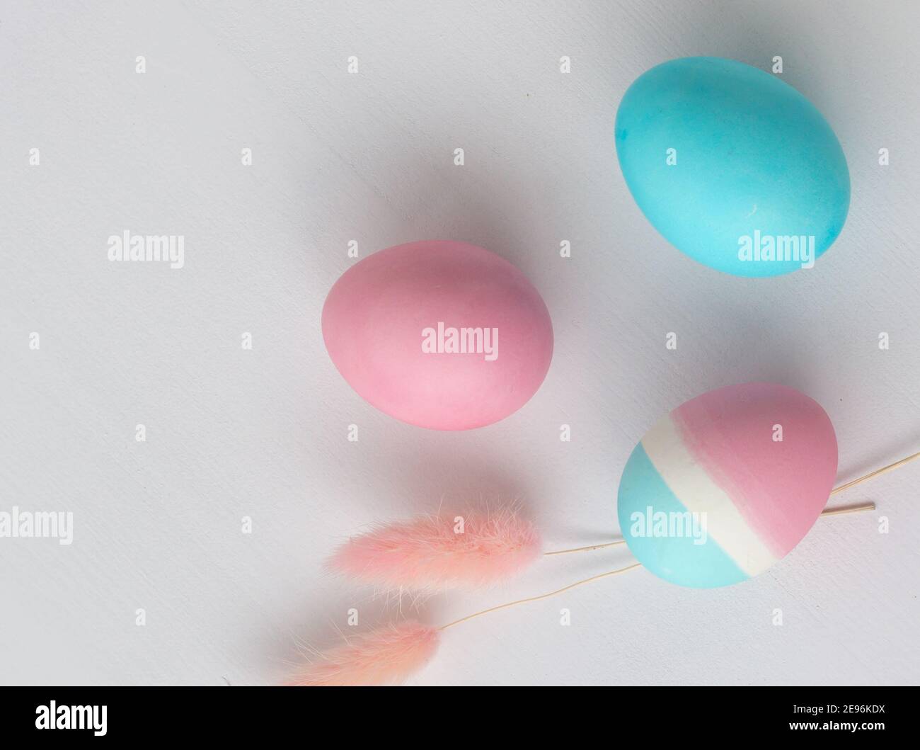 Delicate colors of Easter eggs on a white table, close-up Stock Photo