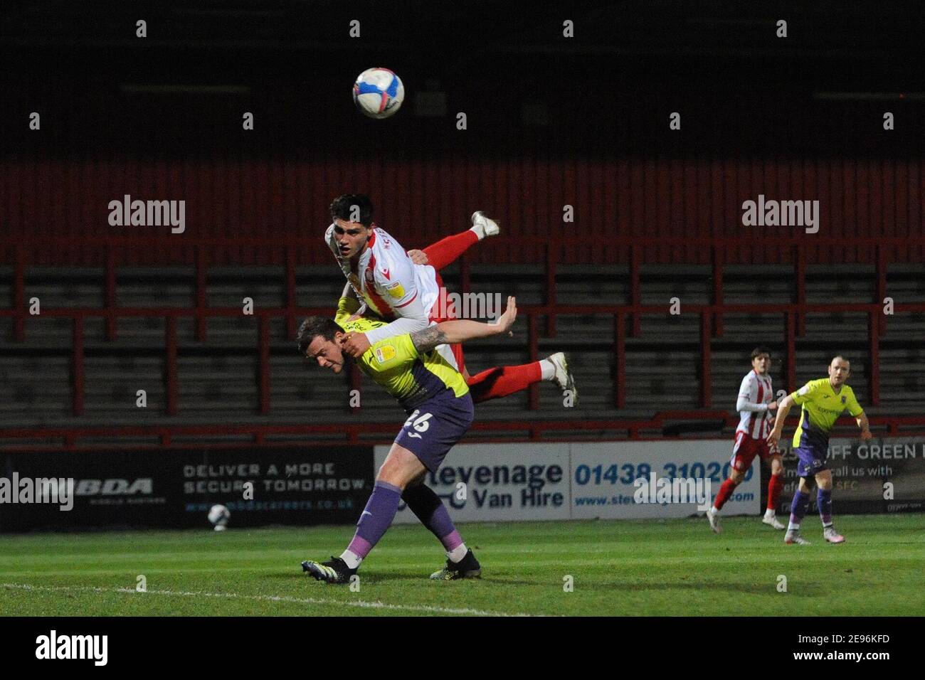 Stevenage, Hertfordshire, UK. 2nd Feb 2021. Stevenages Matt Stevens climbs over Exeters Pierce Sweeney during the Sky Bet League 2 match between Stevenage and Exeter City at the Lamex Stadium, Stevenage on Tuesday 2nd February 2021. (Credit: Ben Pooley | MI News) Credit: MI News & Sport /Alamy Live News Stock Photo
