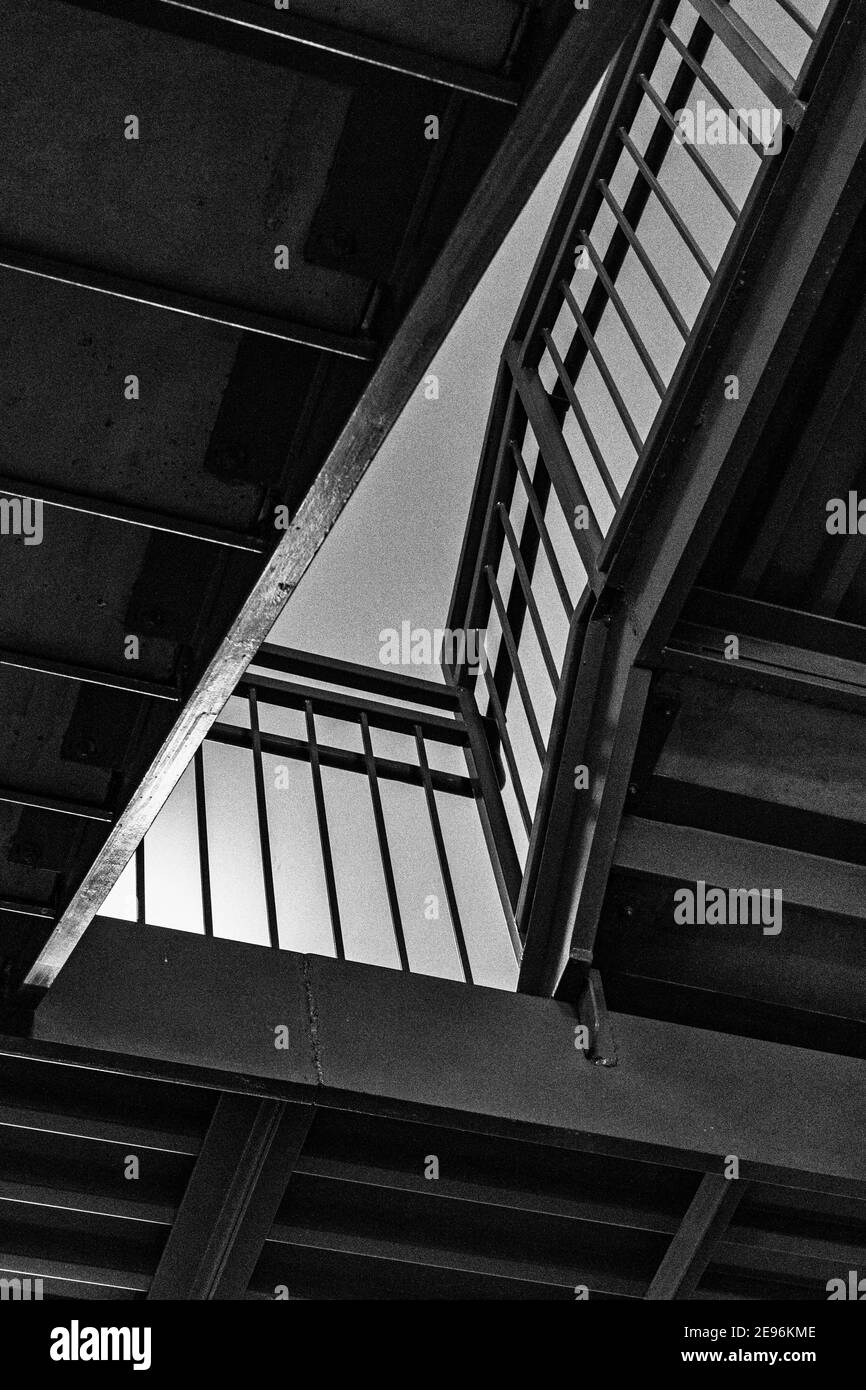 The lines of steps and railings in a stairwell create an abstract design. Stock Photo