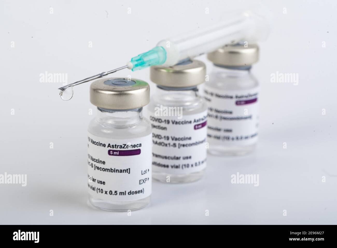 Three Covid-19 vaccine vials with white background and a syringe to ...