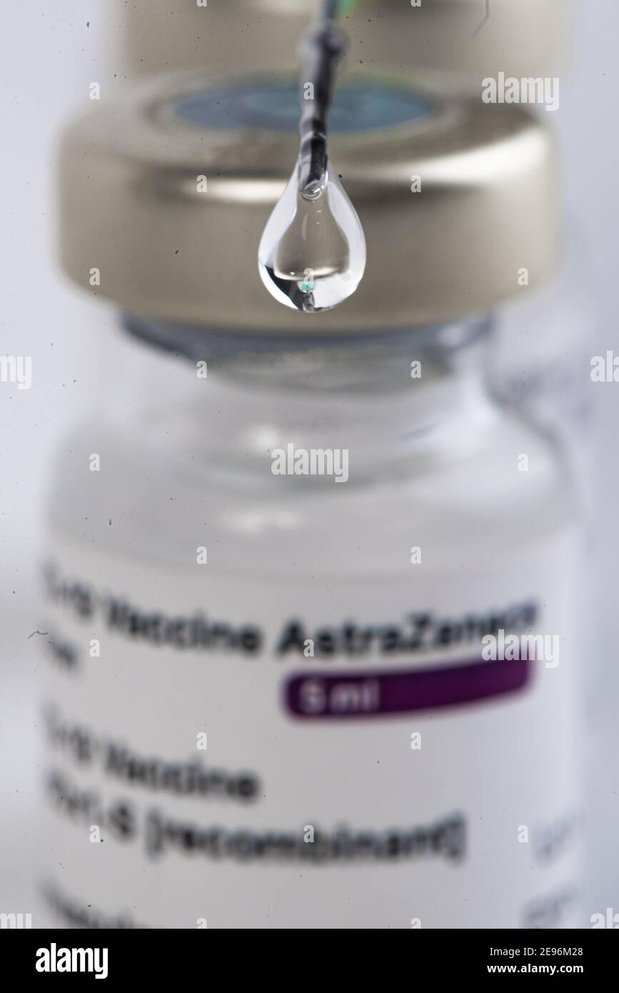 Three Covid-19 vaccine vials with white background and a syringe to ...