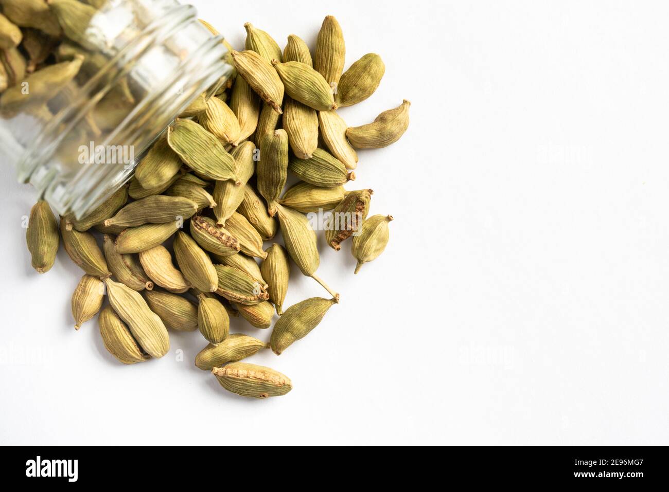 Green Cardamom Pods Spilled from a Spice Jar Stock Photo - Alamy