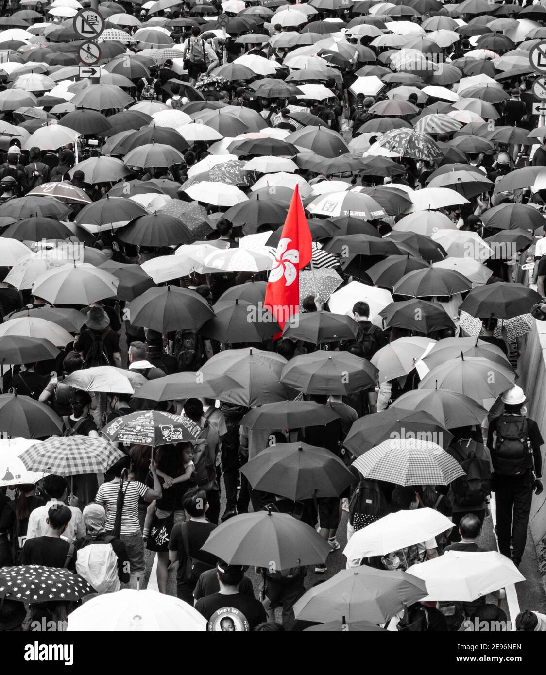 Thousands march peacefully through Central Hong Kong 31 August 2019.  Virtually everyone has an umbrella and a single Hong Kong flag is carried with the crowd.  Taken from above. Stock Photo