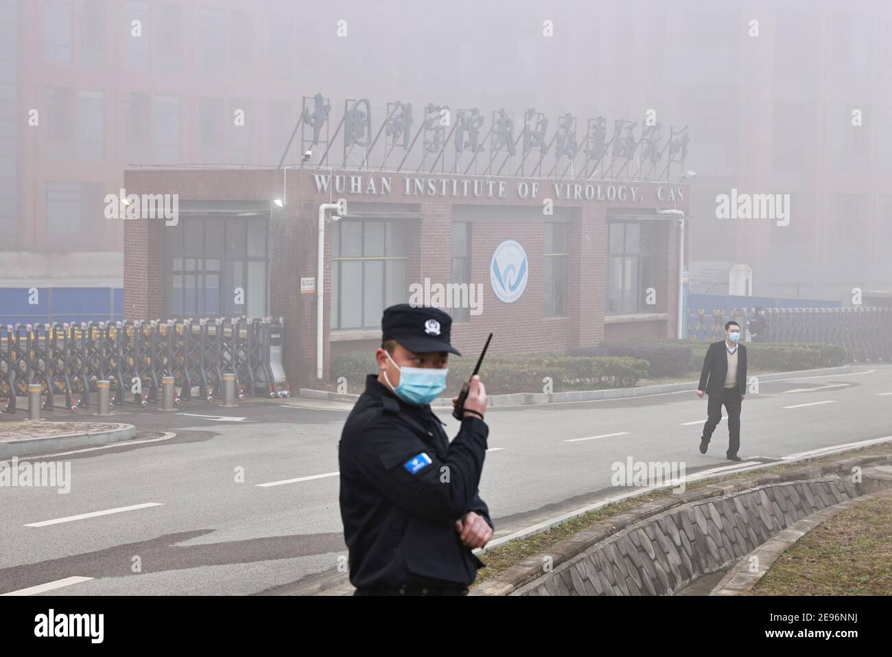 Security personnel stand outside Wuhan Institute of Virology as members of the World Health Organization (WHO) team tasked with investigating the origins of the coronavirus disease (COVID-19) arrive for a visit, in Wuhan, Hubei province, China February 3, 2021. REUTERS/Thomas Peter Stock Photo