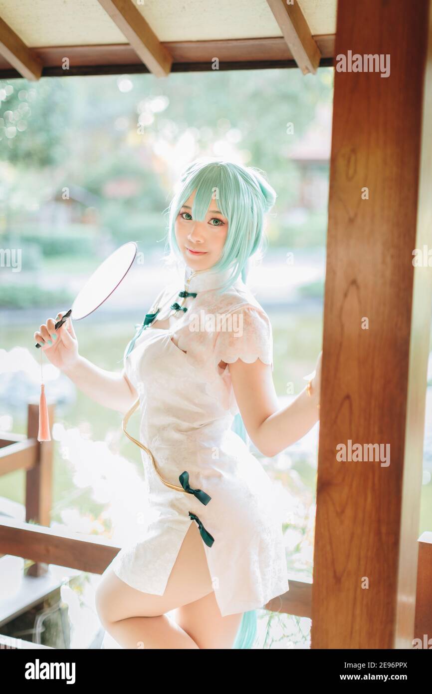 Japan anime cosplay portrait of a girl with chinese dress costume in  chinese garden Stock Photo - Alamy