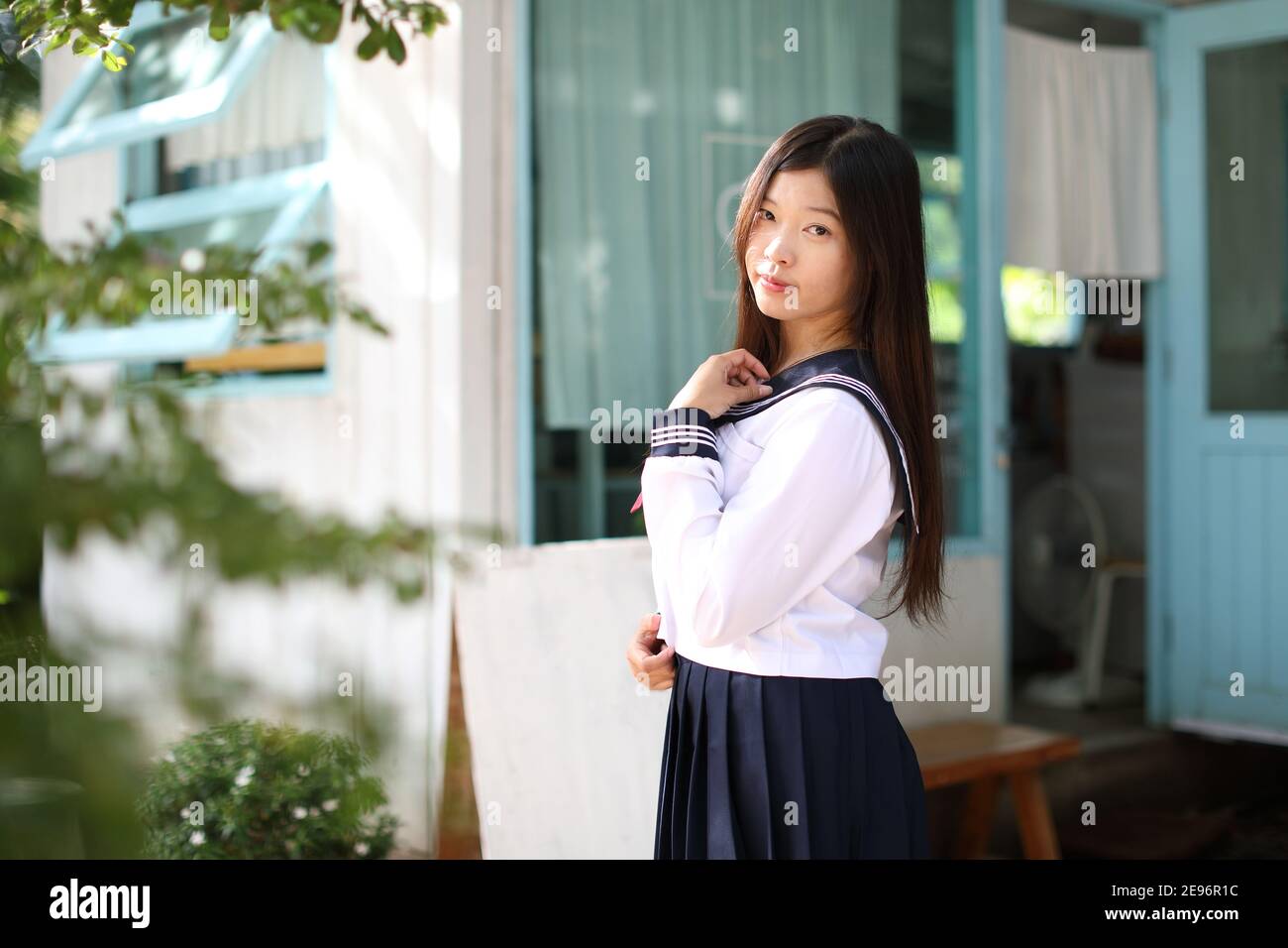 Japanese school girl in local coffee shop Stock Photo
