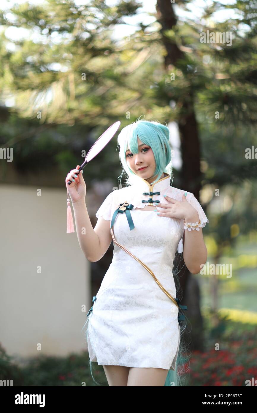 Japan anime cosplay portrait of a girl with chinese dress costume in chinese  garden Stock Photo - Alamy