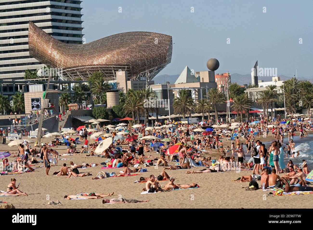 People fun and sunbathing at Barceloneta Beach in Barcelona, Spain. Stock Photo