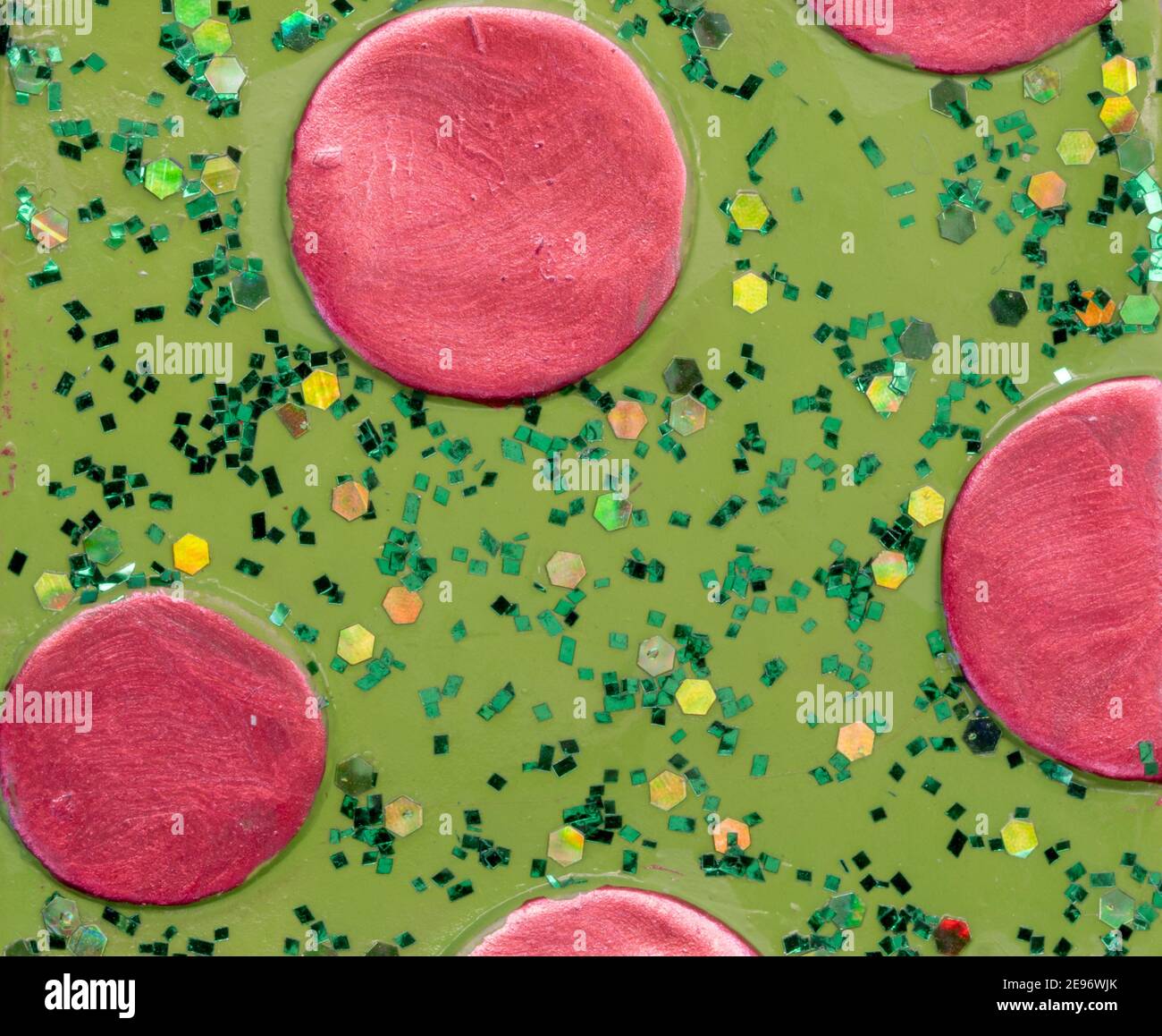 Hand painted pink circles on green with green glitter background Stock