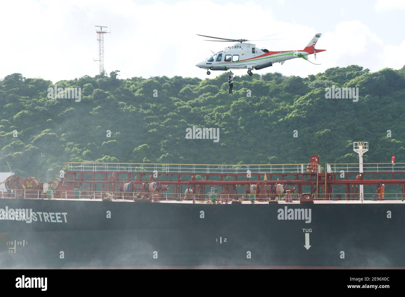Helicopter flying, aircraft of port authority hoisting man