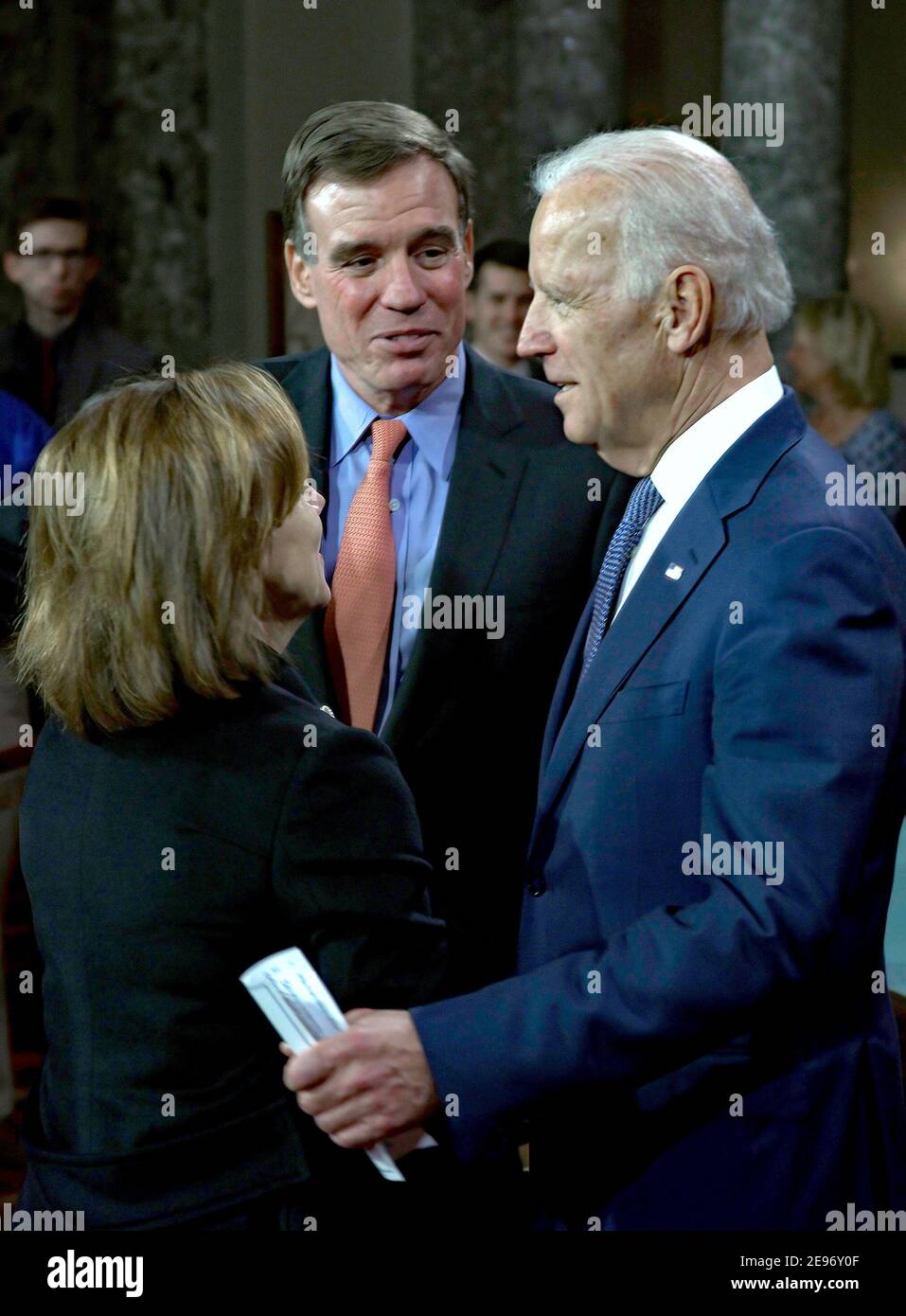 Washington DC, USA, January 6, 2015Lisa Collis the wife of Senator Mark Warner (D-VA) stands next to him as he chats with Vice President Joe Biden (D) prior to Biden administrating the oath of office to Warner in the Old Senate Chamber Credit: Mark Reinstein/MediaPunch Stock Photo