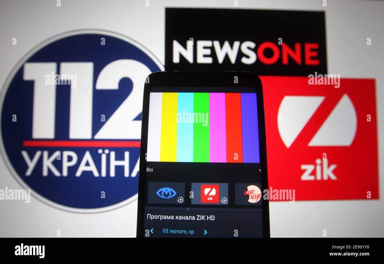 In this photo illustration a rainbow TV test pattern without broadcast on Zik TV channel is seen displayed on a mobile phone screen in front of 112 Ukraine, NewsOne and ZIK logos of Ukrainian TV channels.112 Ukraine, NewsOne and ZIK Ukrainian TV channels are blocked in Ukraine, as Ukraine's media reported late evening on February 02. Ukrainian President Volodymyr Zelensky has put into force a decision by the National Security and Defence Council of February 2, 2021, on applying sanctions against lawmaker Taras Kozak, who is believed to be an ally of pro-Russian politician and the Chairman of t Stock Photo