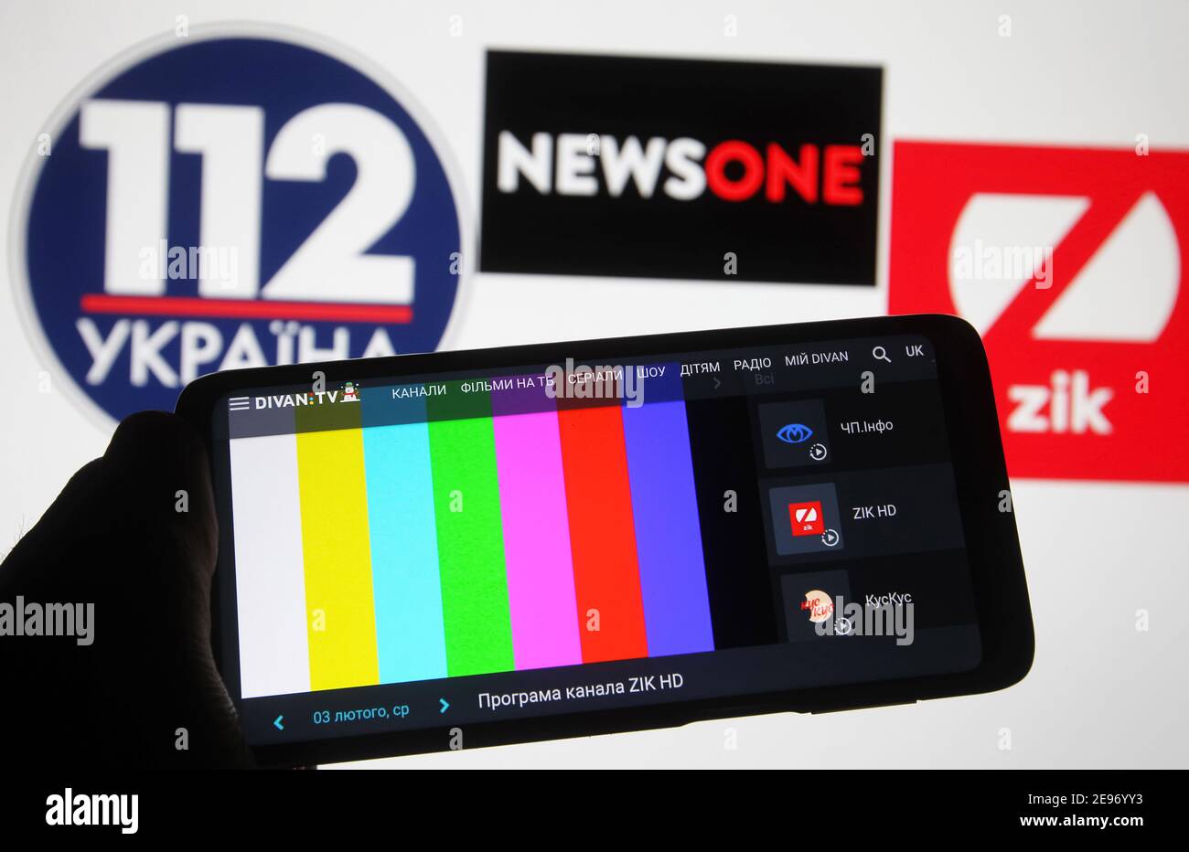 In this photo illustration a rainbow TV test pattern without broadcast on Zik TV channel is seen displayed on a mobile phone screen in front of 112 Ukraine, NewsOne and ZIK logos of Ukrainian TV channels.112 Ukraine, NewsOne and ZIK Ukrainian TV channels are blocked in Ukraine, as Ukraine's media reported late evening on February 02. Ukrainian President Volodymyr Zelensky has put into force a decision by the National Security and Defence Council of February 2, 2021, on applying sanctions against lawmaker Taras Kozak, who is believed to be an ally of pro-Russian politician and the Chairman of t Stock Photo