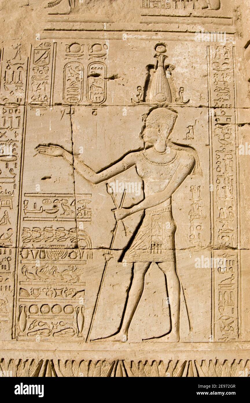 Ancient Egyptian bas relief carving of a Pharaoh. Outer wall of Dendera Temple near Qena. Stock Photo