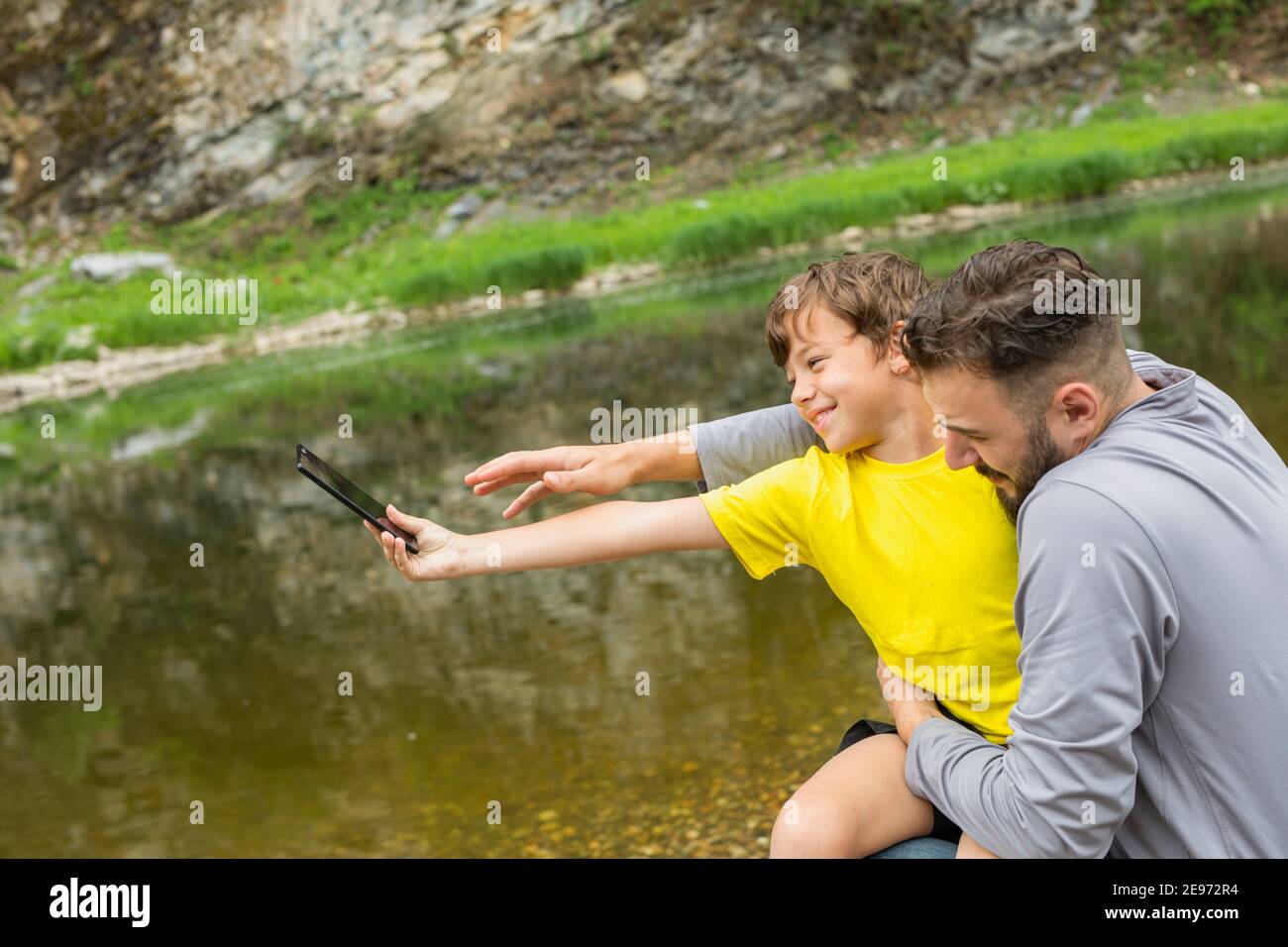 Father son having fun smartphone hi-res stock photography and images ...