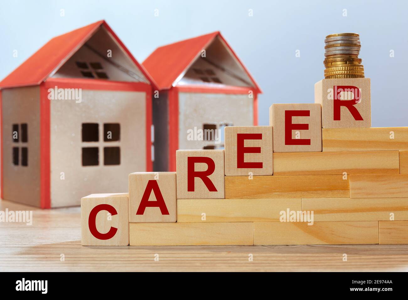 House models and inscription on wooden cubes - CAREER. Real estate investment concept. Stock Photo