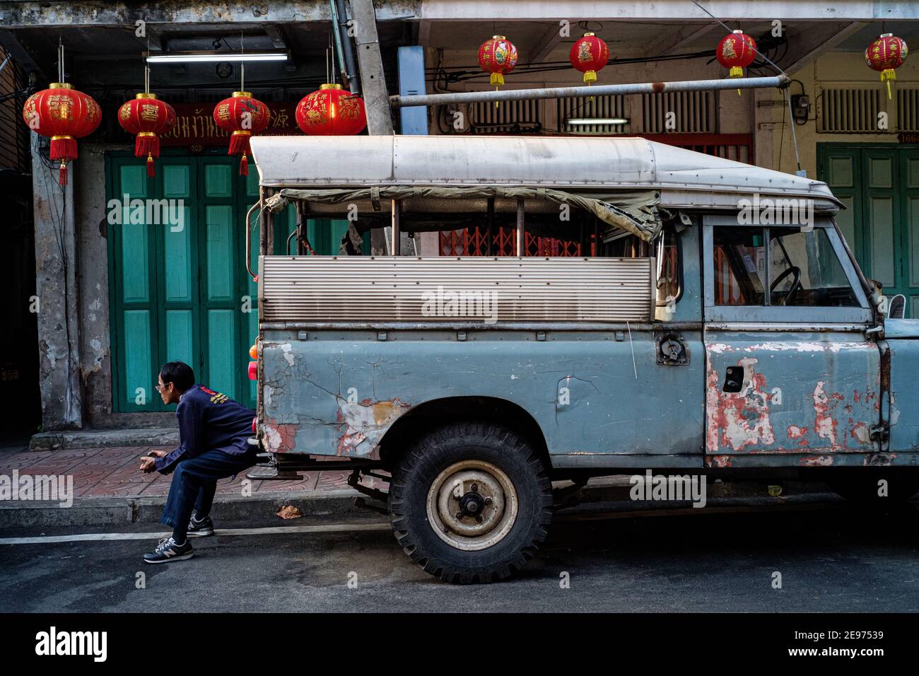 On the streets of bangkok, waiting to load the old land rover defender. Stock Photo