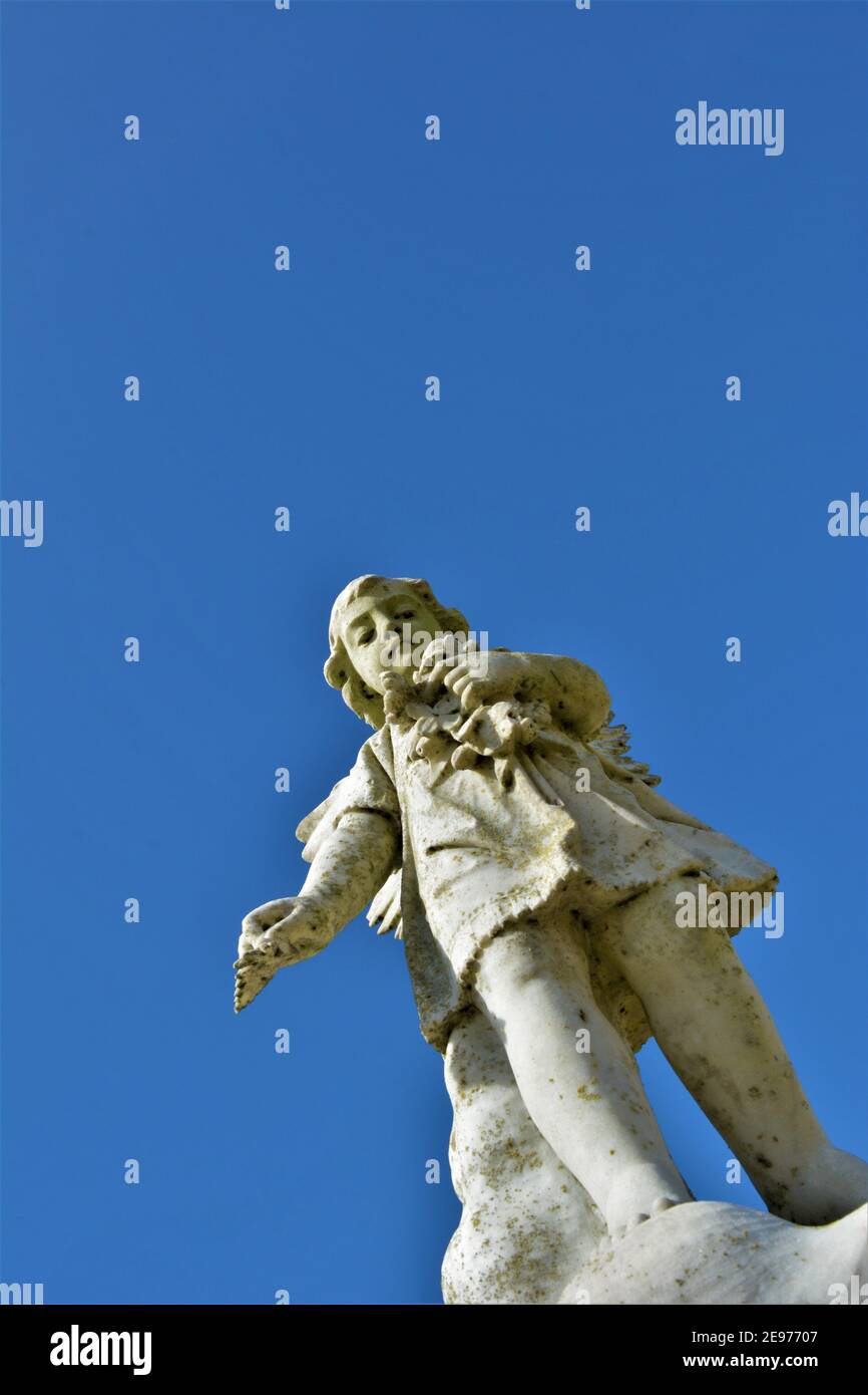 Angel statues in a California Catholic public cemetery with open sky