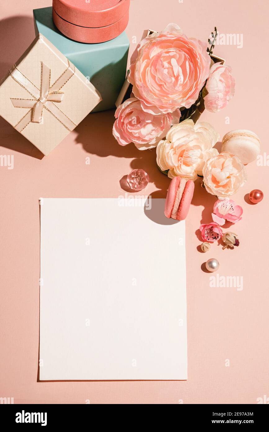Abstract background with flowers, gifts boxes and a template for cards, invitations in pastel muted colors. Stock Photo
