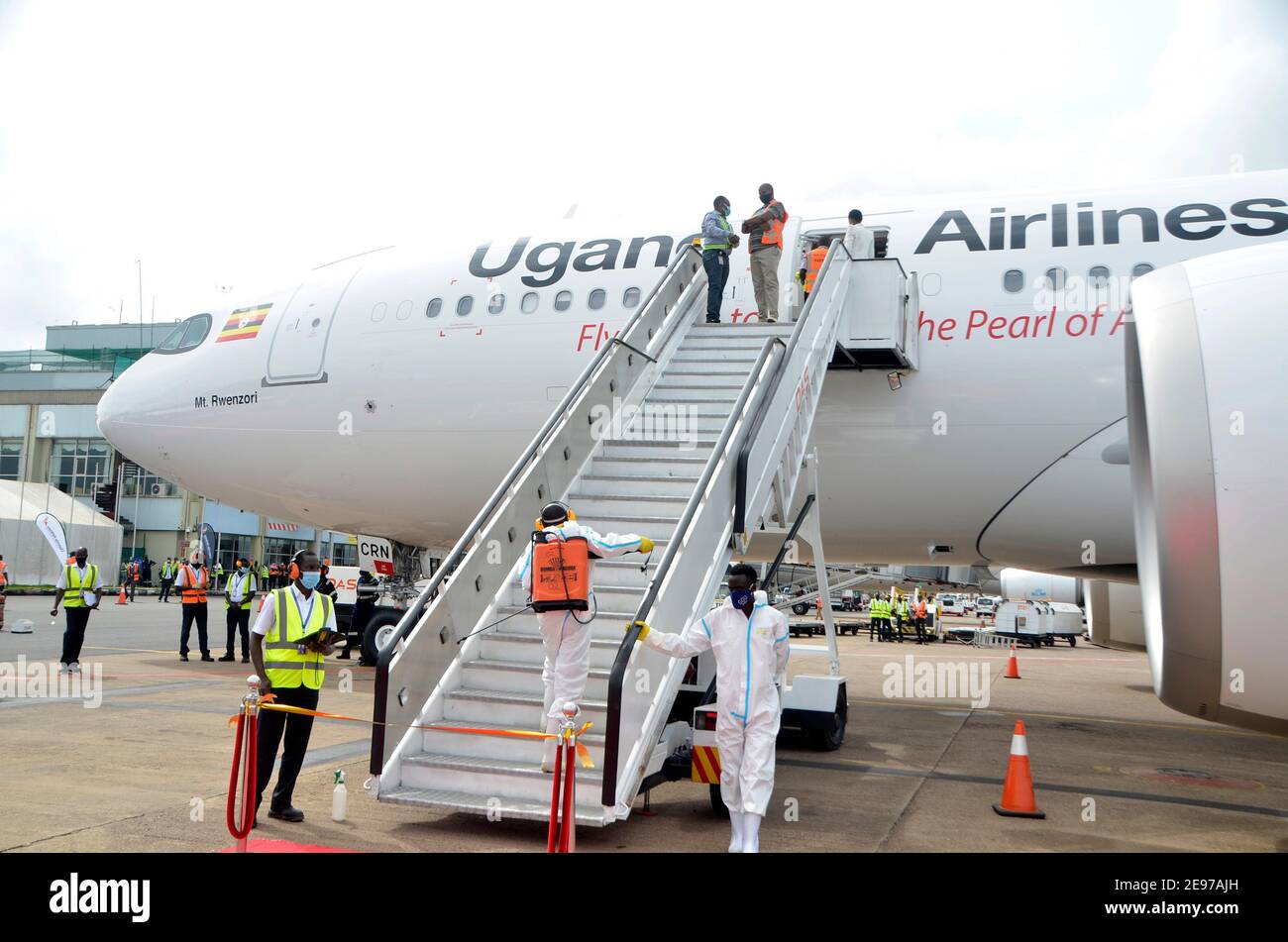 Entebbe, Uganda. 02nd Feb, 2021. Workers in protective suits disinfect