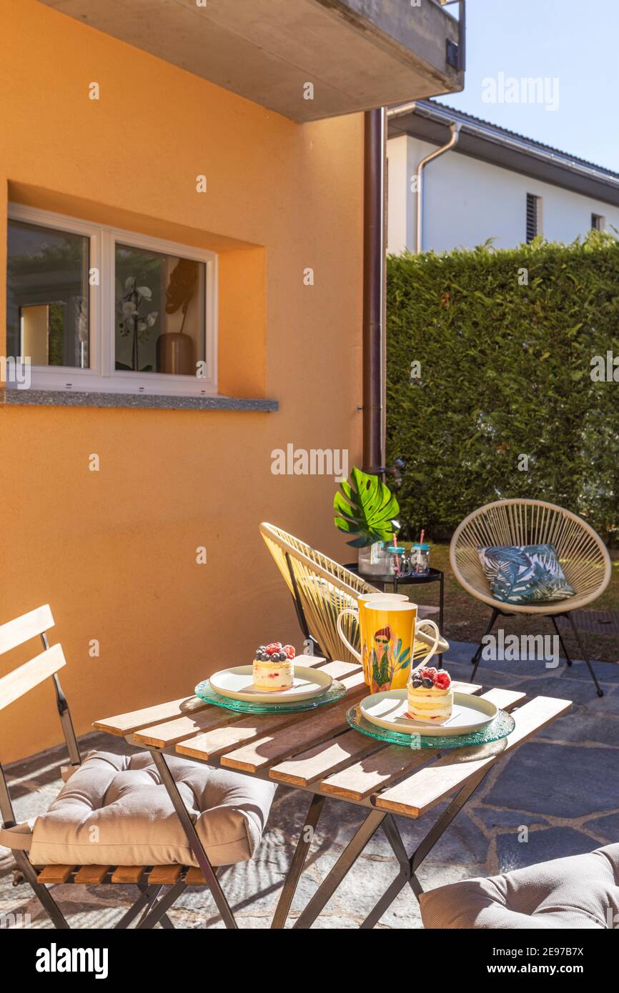 Warm patio with sun in spring day. Everything is ready for a intimate break. Nobody inside Stock Photo
