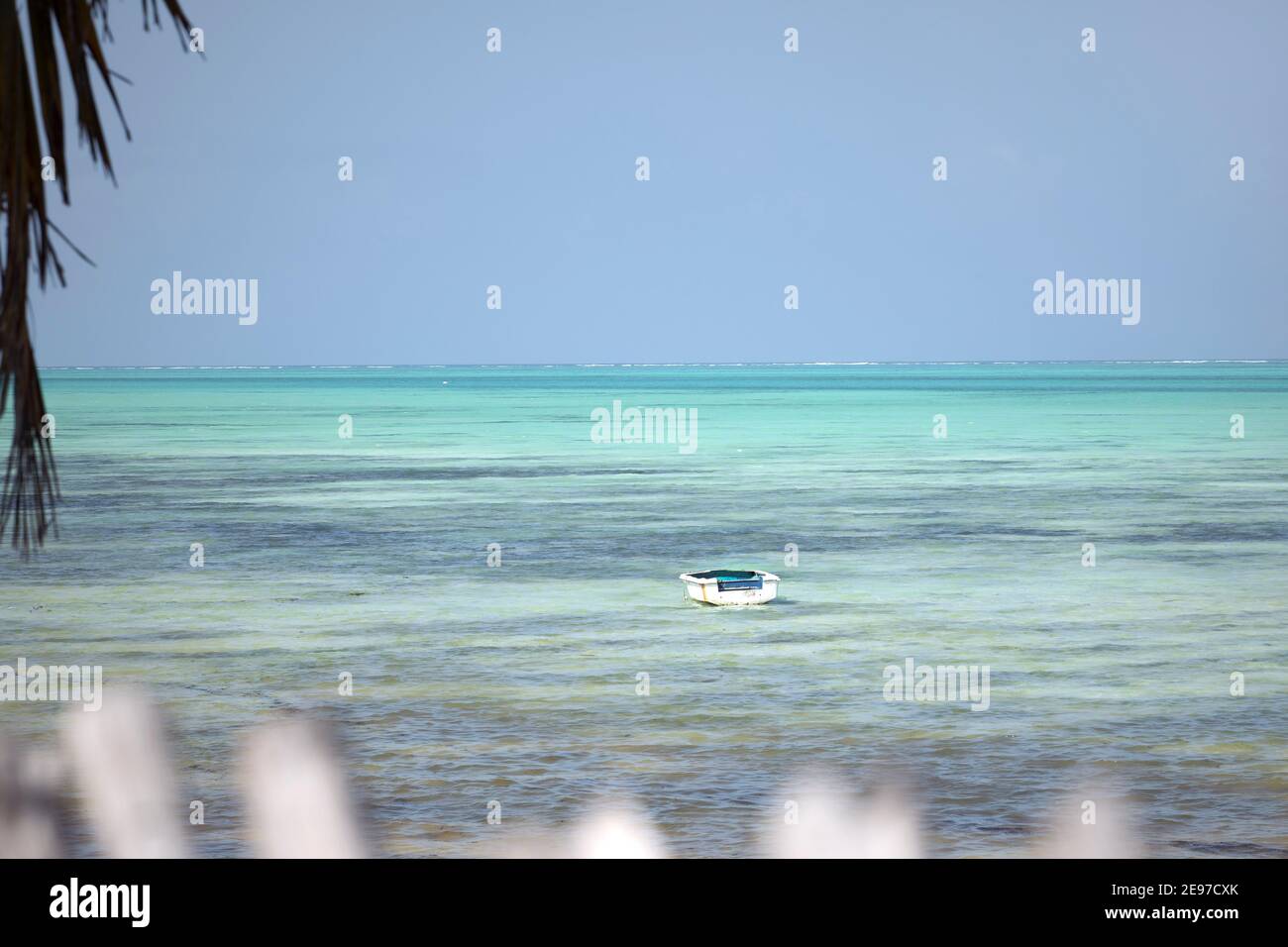 Old wooden boat floating in turquoise water of indian ocean. Tropical ...