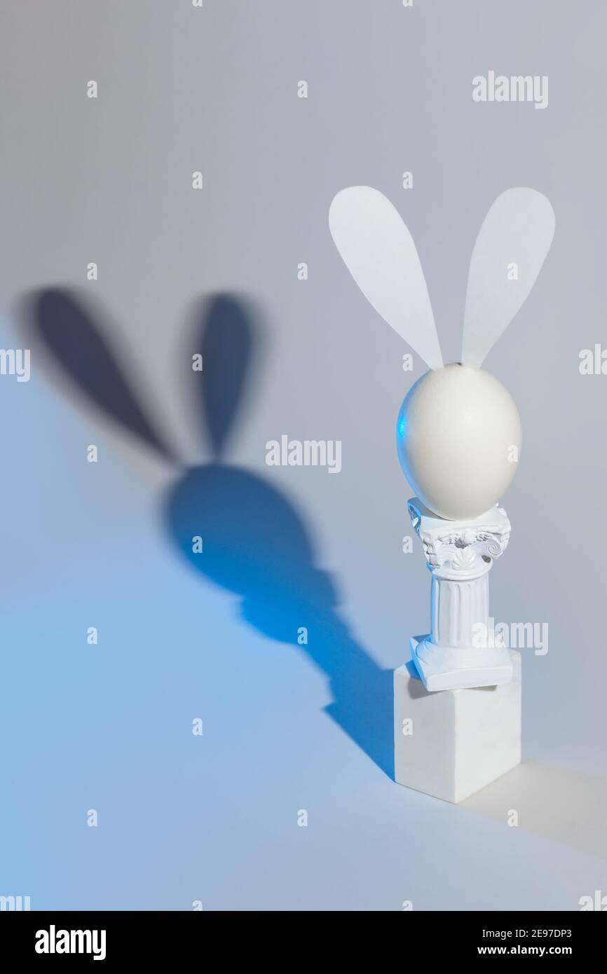 Easter bunny of eggs and columns on a gray background Stock Photo - Alamy