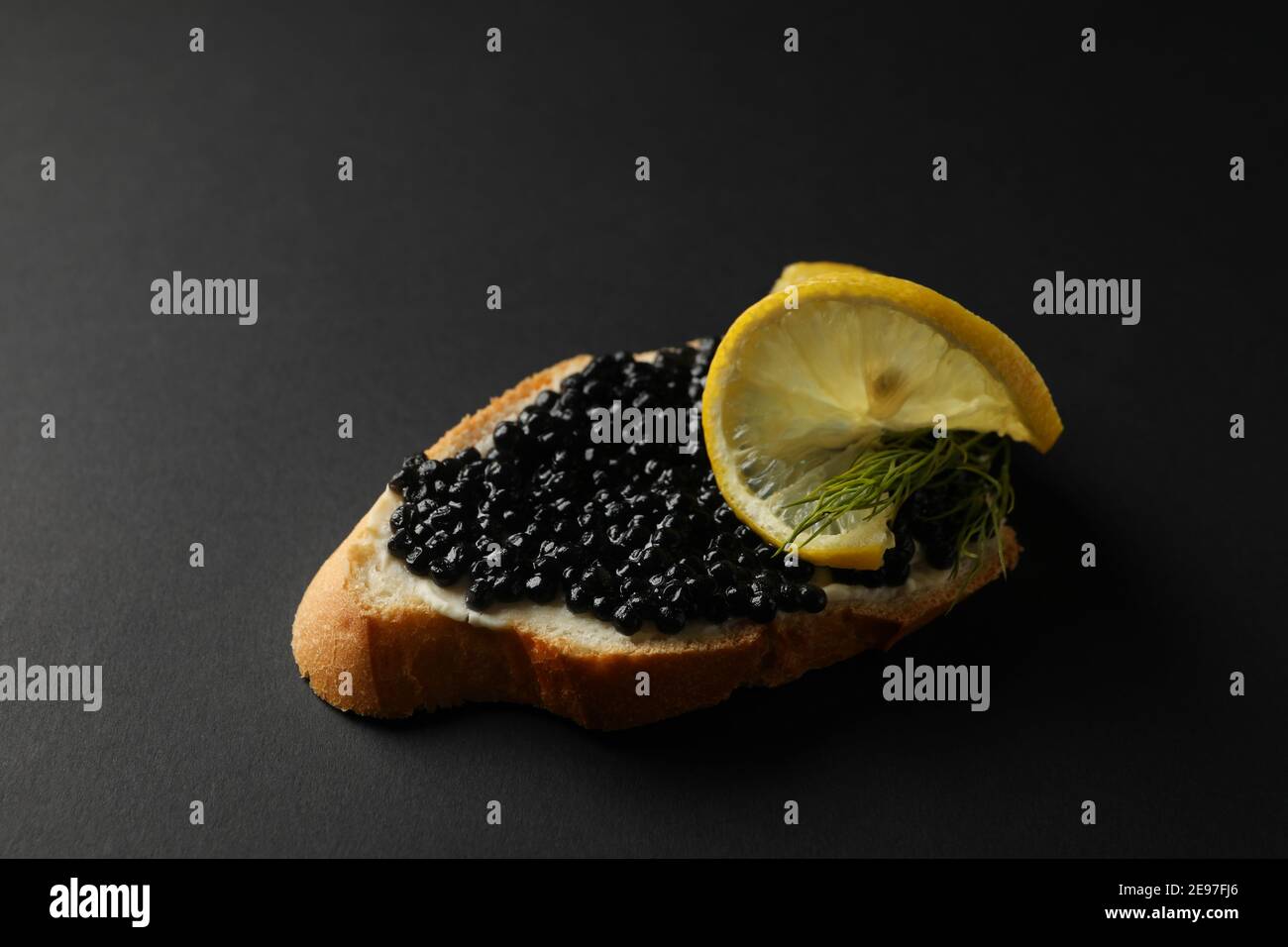 Delicious sandwich with caviar on black background Stock Photo